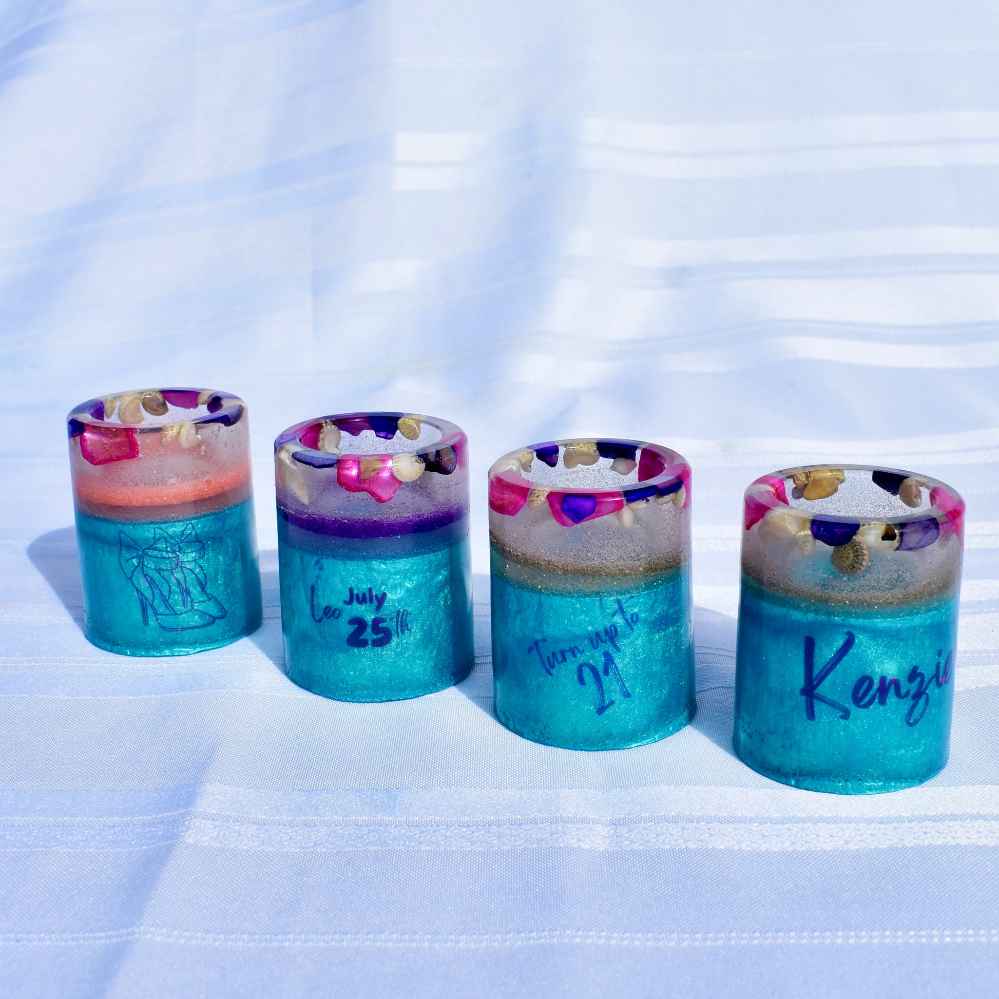 Set of beach-themed resin shot glasses personalized with name, birthdate, Leo zodiac sign, high heels, and a microphone.